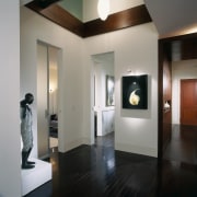 A view of a hallway, wooden flooring, spot ceiling, exhibition, floor, interior design, lobby, gray, black