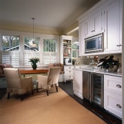 A view o fthe kitchen, wooden table, chairs cabinetry, countertop, cuisine classique, floor, flooring, hardwood, home, interior design, kitchen, living room, room, window, wood flooring, gray