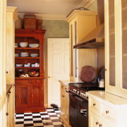 Classic style kitchen with cream cabinetry with mesh cabinetry, countertop, cuisine classique, floor, flooring, furniture, hardwood, home, interior design, kitchen, room, wood, wood flooring, wood stain, orange