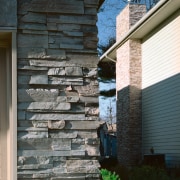 Closeup view of exterior stone siding. - Closeup architecture, brick, brickwork, facade, home, house, siding, stone wall, structure, wall, window, wood, black