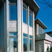 Exterior view of apartment showing patterned glass windows. architecture, building, commercial building, elevation, facade, home, house, property, real estate, residential area, sash window, siding, structure, window, gray, black
