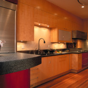designer verno has remodelled this galley kitchen, featuring cabinetry, ceiling, countertop, cuisine classique, floor, flooring, hardwood, interior design, kitchen, real estate, room, under cabinet lighting, wood flooring, brown