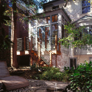 An exterior view of the home. - An building, cottage, home, house, neighbourhood, outdoor structure, property, real estate, residential area, tree, window, black