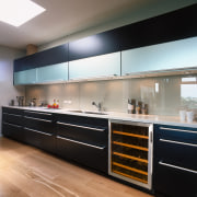 Kitchen with dark cabinetry, long chrome handles, and cabinetry, countertop, interior design, kitchen, black, gray