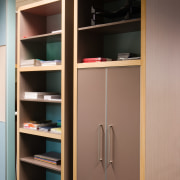 A view of some office furniture. - A cabinetry, closet, cupboard, furniture, shelf, shelving, brown