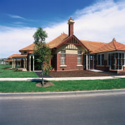 Historical brick building now part of the Commonwealth building, cottage, estate, facade, farmhouse, home, house, land lot, mansion, property, real estate, residential area, roof, sky, suburb