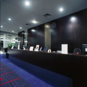 Counter area with timber counter and walll panelling. architecture, ceiling, interior design, lighting, lobby, black, gray