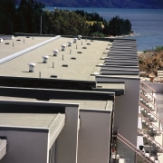 View of apartment building's roofing system. - View architecture, daylighting, facade, outdoor structure, real estate, roof, gray, black