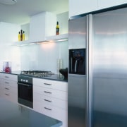 Kitchen with cream cabinetry and stainless steel oven, cabinetry, countertop, home appliance, interior design, kitchen, major appliance, product design, refrigerator, white, gray