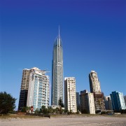 View of tall apartment buildings. - View of building, city, cityscape, condominium, corporate headquarters, daytime, downtown, landmark, metropolis, metropolitan area, mixed use, sky, skyline, skyscraper, tower, tower block, urban area, blue