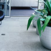 Glass enclosed balcony with porcelain vitrified floor tiles. floor, flooring, hardwood, plant, product design, table, tile, gray