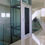 View of elevator with glass sides and door, door, glass, property, window, gray