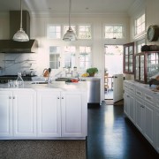 view of this white kitchen featuring white painted cabinetry, countertop, cuisine classique, floor, flooring, home, interior design, kitchen, room, window, gray, white