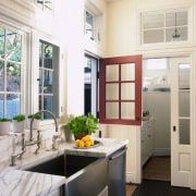view of this white kitchen featuring white painted cabinetry, countertop, cuisine classique, home, home appliance, interior design, kitchen, window, white