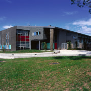 Exterior view of aquatic and leisure centre with architecture, building, commercial building, corporate headquarters, facade, real estate, sky, blue