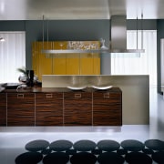 A view of a Pedini kitchen with brown cabinetry, countertop, cuisine classique, floor, flooring, interior design, kitchen, product design, room, gray, black