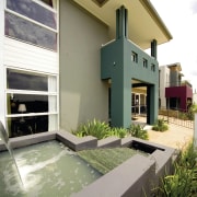 A view of a Clarendon Home. - A architecture, building, courtyard, elevation, estate, facade, home, house, property, real estate, residential area, villa, window, white