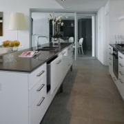 Kitchen with white cabinetry and black benchtop, and cabinetry, countertop, cuisine classique, floor, flooring, interior design, kitchen, room, tile, wood flooring, gray