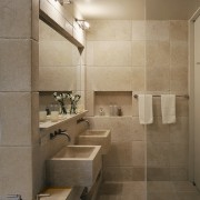 View of this bathroom featuring two seater bathtub, architecture, bathroom, floor, flooring, interior design, plumbing fixture, room, sink, tile, wall, brown, orange