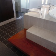 view of the tiled bath surround and timber bathroom, countertop, floor, flooring, hardwood, interior design, laminate flooring, sink, tile, wall, wood, wood flooring, gray, black