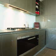 view of this kitchen featuring miele five burner architecture, cabinetry, countertop, floor, home appliance, interior design, kitchen, major appliance, room, sink, brown, black