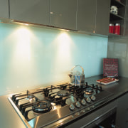 view of this kitchen featuring miele five burner countertop, glass, interior design, kitchen, room, under cabinet lighting, black, gray