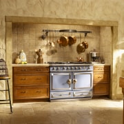 Traditional style kitchen with wood cabinetry, stone walls cabinetry, countertop, cuisine classique, furniture, interior design, kitchen, room, brown, orange