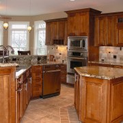 Kitchen with timber cabinetry, granite countertops, stainless steel cabinetry, countertop, cuisine classique, floor, flooring, hardwood, home, interior design, kitchen, room, wood, wood flooring, wood stain, brown