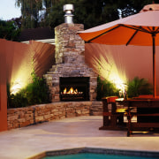 Outdoor fireplace in poolside setting with brick chimney backyard, estate, home, landscaping, lighting, outdoor structure, patio, real estate, swimming pool, black, red