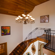 Stairway and foyer area with cream walls and ceiling, chandelier, dining room, estate, floor, handrail, home, house, interior design, light fixture, property, real estate, room, stairs, wood, brown