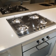 view of this kitchen in yve apartments featuring countertop, gas stove, home appliance, kitchen, kitchen stove, product design, white, gray