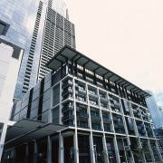 view of the curtain wall facade at freshwater architecture, brutalist architecture, building, city, commercial building, condominium, corporate headquarters, daytime, downtown, facade, headquarters, infrastructure, landmark, metropolis, metropolitan area, mixed use, neighbourhood, sky, skyscraper, structure, tower block, urban area, white, black, gray