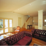 A view of a cottage renovated by Cape ceiling, estate, floor, flooring, home, house, interior design, living room, property, real estate, room, window, orange, brown
