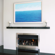 Gas fireplace with stainless steel trim, white surround display device, fireplace, flat panel display, hearth, white