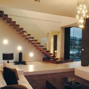 A view of a NSD home. - A ceiling, interior design, living room, property, real estate, room, stairs, wall, orange