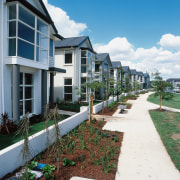 View of white two storey homes with grass apartment, condominium, estate, home, house, neighbourhood, property, real estate, residential area, sky, walkway, teal, white