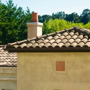 View of masonry home with clay roofing tiles. chimney, estate, facade, home, house, outdoor structure, real estate, roof, window, brown, orange