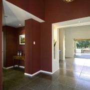 Entrance area of home with brown walls, white apartment, architecture, ceiling, daylighting, estate, floor, flooring, hardwood, home, house, interior design, living room, lobby, property, real estate, room, wall, window, wood, wood flooring, red, gray