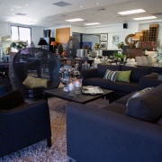 View of showroom with closeup of dark coloured furniture, interior design, living room, lobby, gray, blue