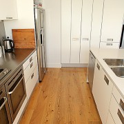 View of kitchen with timber flooring, white cabinetry cabinetry, countertop, floor, flooring, hardwood, home, interior design, kitchen, laminate flooring, room, tile, wood, wood flooring, white