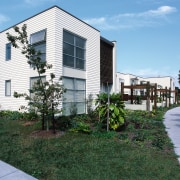 View of white two storey home with grass apartment, architecture, building, condominium, corporate headquarters, cottage, estate, facade, home, house, mixed use, neighbourhood, property, real estate, residential area, suburb, teal