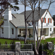 Large cream coloured masonry home with steep shingle building, cottage, estate, facade, farmhouse, historic house, home, house, mansion, neighbourhood, property, real estate, residential area, roof, tree, window, gray, black