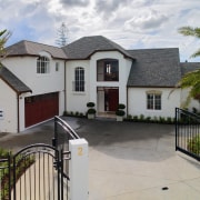 Large cream coloured masonry home with steep shingle building, cottage, estate, facade, home, house, neighbourhood, property, real estate, residential area, roof, window, gray