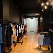 A view of a store, wooden flooring. - boutique, interior design, room, black