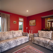 Lounge room with red walls and floral upholstered ceiling, estate, floor, flooring, home, interior design, living room, property, real estate, room, wall, window, brown, red, gray