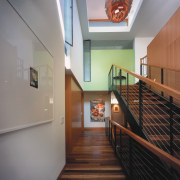 view of the hallway and staircase featuring orange apartment, architecture, ceiling, daylighting, estate, floor, flooring, handrail, hardwood, home, house, interior design, property, real estate, stairs, wood, gray