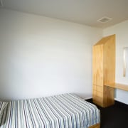 A view of a bedroom, blue carpet, white architecture, bed frame, bedroom, ceiling, daylighting, floor, furniture, house, interior design, real estate, room, wood, gray, white