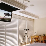 Bedroom with flat screen tv mounted on ceiling. ceiling, daylighting, floor, flooring, home, house, interior design, property, real estate, room, wall, window, window covering, wood, gray