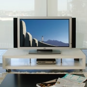 View of plasma screen on white box shaped display device, flat panel display, furniture, interior design, media, multimedia, product design, table, television, gray, white