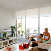 Lounge room with plasma screen on white shelf. ceiling, home, interior design, living room, real estate, room, window, window covering, gray